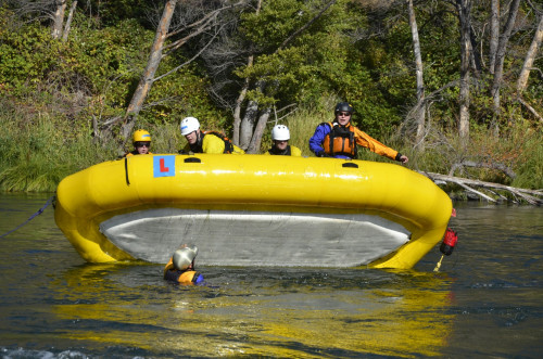 Participants learn how to flip their raft to prepare for worst-case scenarios.