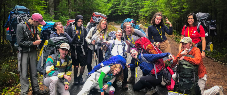 Image Description: A group of people dressed for backpacking make a silly pose