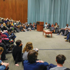 The symposium's panels drew large, attentive crowds.