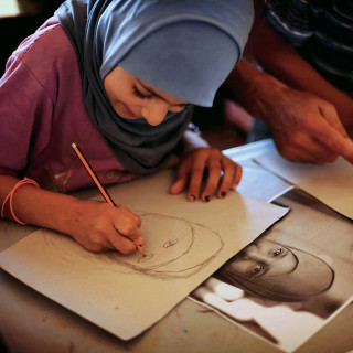 A young artist in the Zaatari refugee camp, Jordan (Photo by Samantha Robison BA '08)