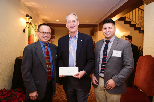 In the spirit of the season, Moses Lee (left) and Jason Lee (right) of the M.J. Murdock Charitable Trust present President Wim Wiewel wit...