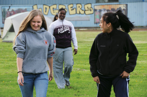 High school students Jessica Willis, Catrice Allyene, and Sarah Ramos head toward a classroom at Mitchell High School, where they will pr...