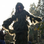 A student wearing a full-body moss suit.