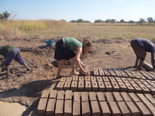 Maddy Kidd '14 making bricks out of the clay that is naturally found in the village. All bricks used to build the school came from this clay.
