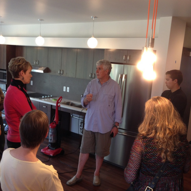 Michel George, associate vice president for facilities, leads a tour of the remodeled Juniper residence hall.