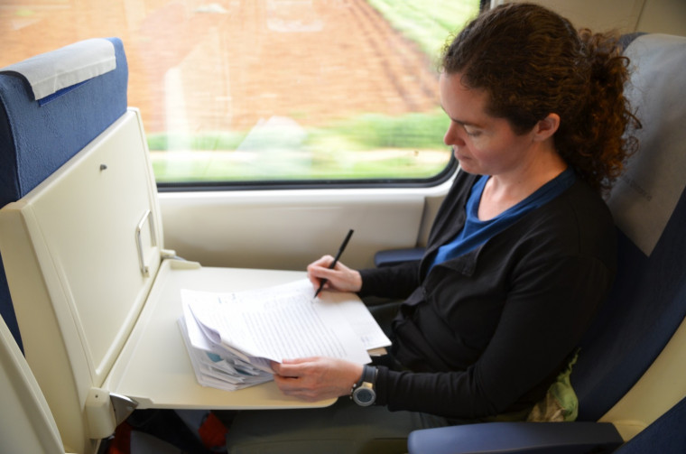 Professor Powers: grading papers on train in Spain