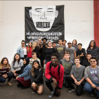 The students in the Portland History class who organized the event with one of their posters.