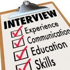 Interview qualifications a job candidate must possess on a checklist clipboard including experience, communication, education and other s...