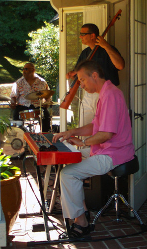 A band entertains partygoers near the house