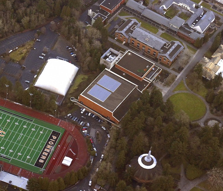 An aerial view of campus shows a solar panel system on the roof of the Pamplin Sports Center.