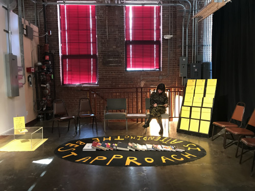 Roz Crews performing as part of her installation, The Beset Approach is Attending, at the New Genre Arts Festival in Tulsa,Oklahoma.