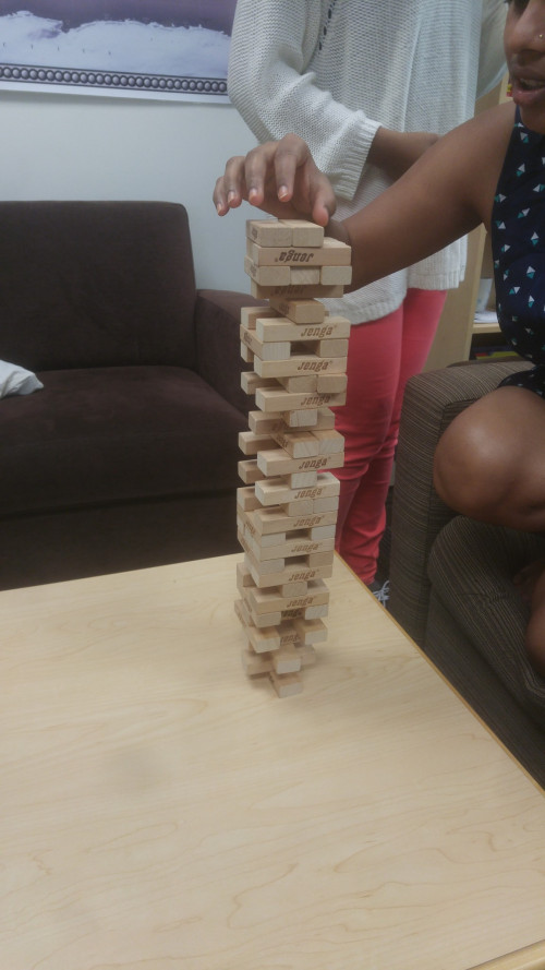 International Students and TCKs play Jenga in the ISS Office.