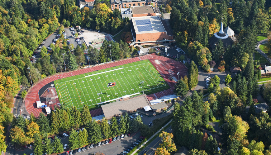 Aerial image of campus, featuring Griswold Stadium among a sea of green trees.