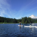 Student Stand Up Paddleboard on a lake with a view of Mt. Hood