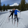 Madeline Swanberg and Gillian Luegers pose during a skate ski trip in front of Mt. Hood.