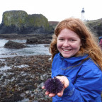 A student holds a sea urchin found tidepooling at the Oregon coast