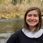 Virginia smiling in front of a river