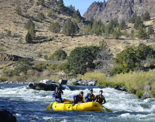 After learning the basics of how to guide a raft, a participant leads her peers down the Deschutes river.