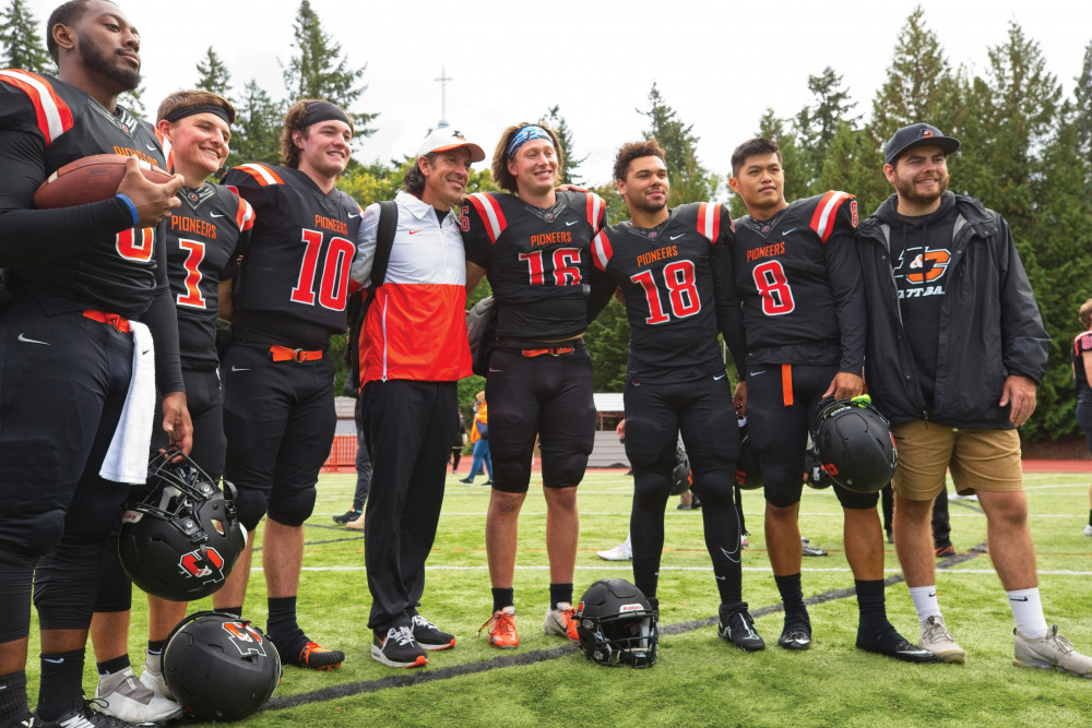 Joe Bushman (center), Lewis &amp; Clark&#039;s new head football coach, surrounded by members of t...