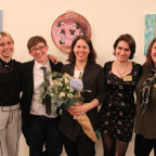 Symposium director Kim Brodkin (center, with  flowers) with student cochairs Hannah Daniels, Alexa Jakusovszky, Em Schuler, and Anya Hall