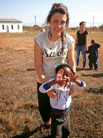 Miriam Coe CAS '14 with a young friend at Mahlanya Neighborhood Care Point.