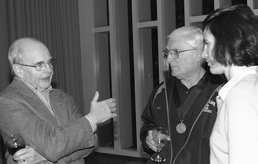 Curt Copenhagen '55 (left) and Jack Venables '56 visit with Liz Safran, associate professor of environmental studies.