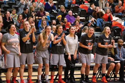 An enthusiastic crowd cheers on the women's basketball team.