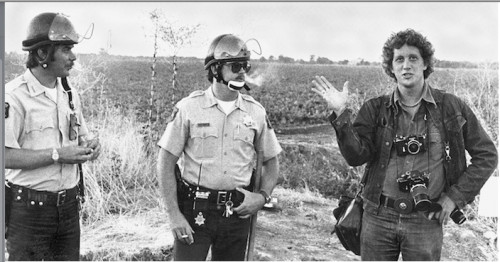 Bob Fitch, far right, accompanied by California Highway Patrol officers. Salinas, California, 1973.