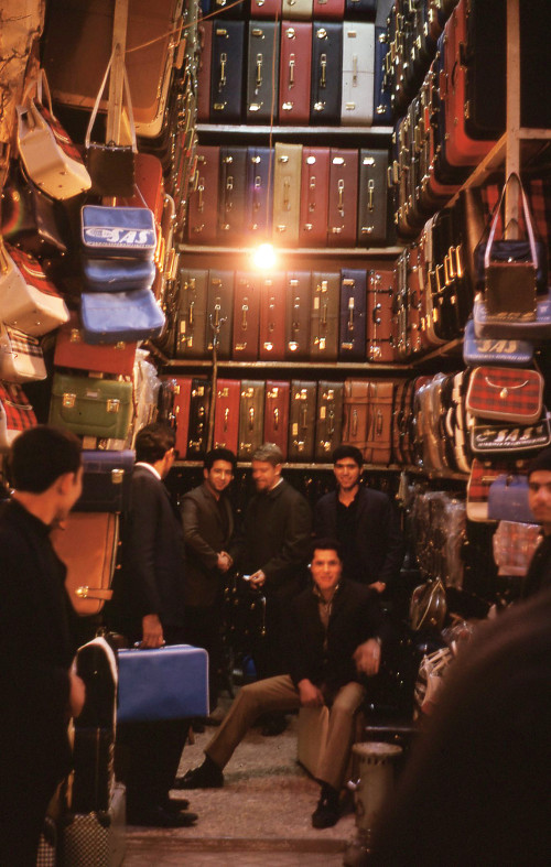 1968: Rick Price '72 (seated) at a suitcase shop in the Tajrish Bazaar, north of Tehran.