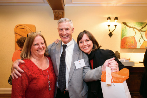 Executive Assistant Moira Domann with Trustee Jon Jaqua and his wife, Kim Cooper. Like the other guests, they received a gift of chocolat...