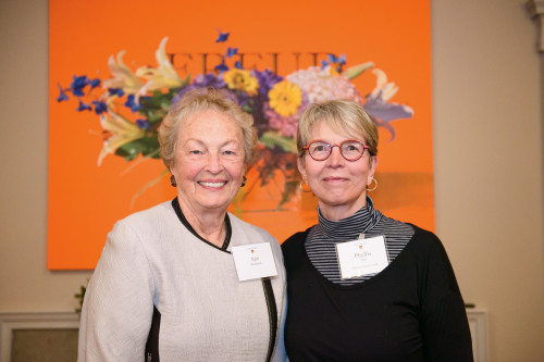 Phyllis Yes (right), professor emerita of art, with Ann Wellman, who donated Yes' painting (shown behind them) to the Cooley House.