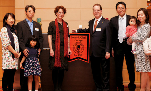 The families of Kei Nagai BA '97 (left) and Toshinobu Toyama BA '97 (right) join Betsy Amster and President Glassner at the Tokyo alu...