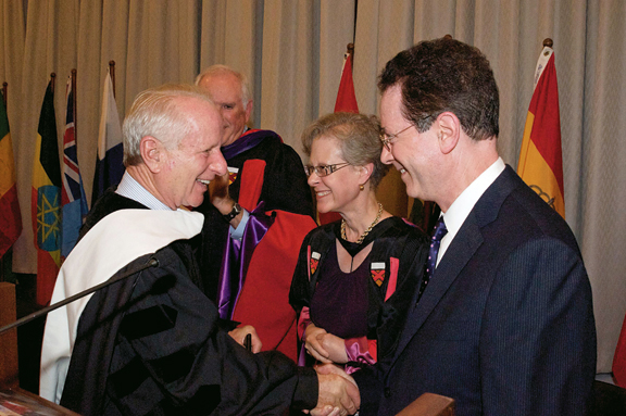 Upon receiving his honorary degree from Lewis & Clark, Shelby Davis is congratulated by Vice President and Provost Jane Atkinson and ...
