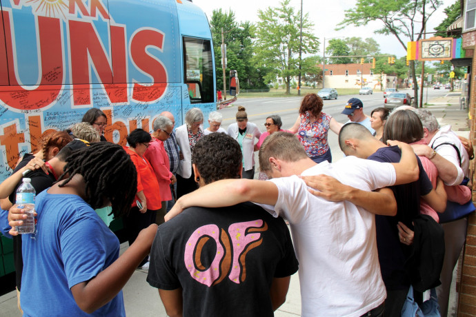 A group hug at a stop along the Nuns on the Bus tour.