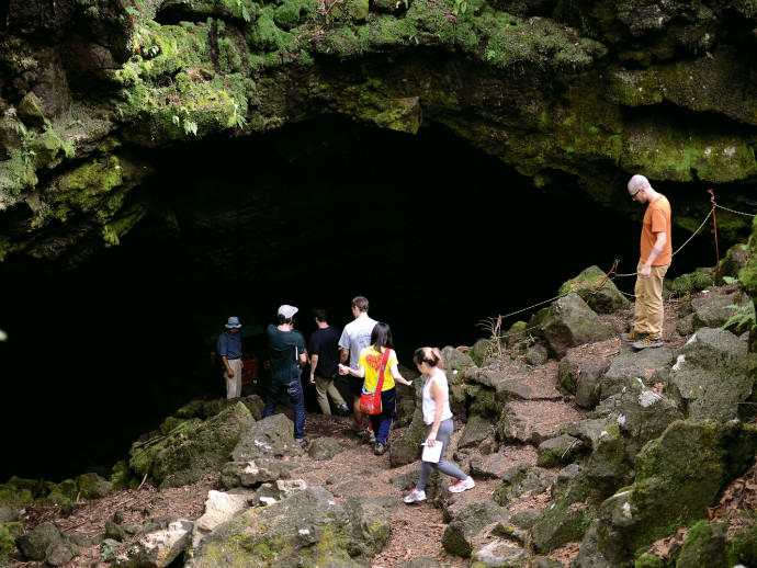 Students enter one of Fuji's lava tubes.