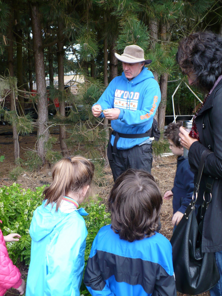 Bob Carlson interacts with kindergarteners on a senses walk in the CREST garden.