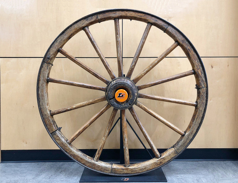 The Wagon Wheel trophy, with a new Lewis & Clark hubcap, on display in the Pamplin Sports Center Hall of Champions.