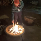This is a picture of Ez Armijo burning a paper in a fire pit during Art for Social Change?s annua...