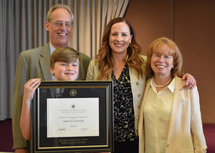 Ambyr O'Donnell '01 (center) poses with Dean Jennifer Johnson, President Wim Wiewel, and son Asht...