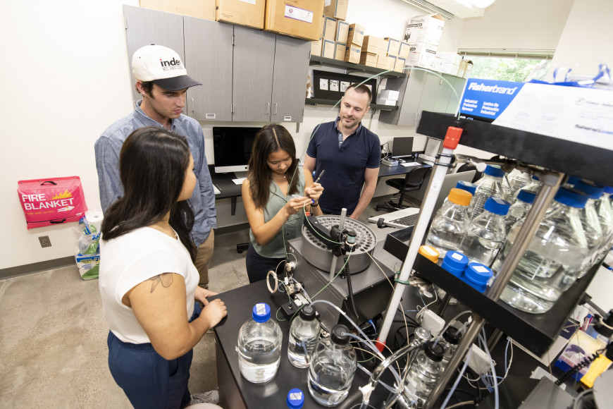 Professor of Chemistry Nikolaus Loening collaborates with students on studying how the interactions between two cellular proteins are reg...