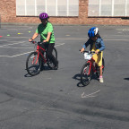 Children learning how to ride a bike