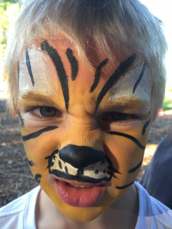 Photo of Alex Holmgren with tiger face paint taken at the 2017 LC Kids and Families picnic.