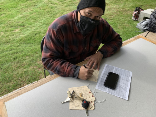 Lawrence Siulagi filling out toe tags for Hostile Terrain 94 event.