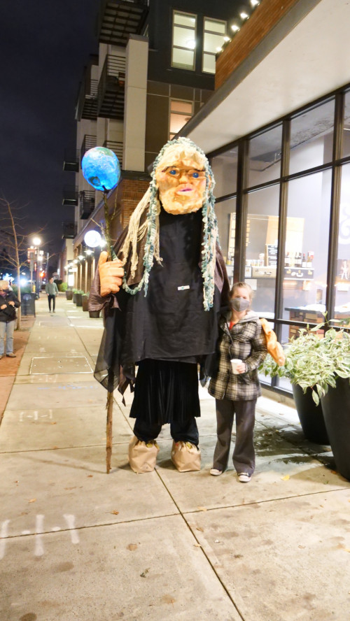 Mary Andrus (in Mother Earth costume), co-chair of Art for Social Change, and a passerby.