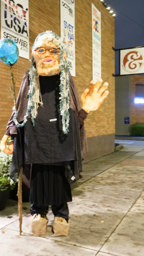 Mary Andrus (in Mother Earth costume), co-chair of Art for Social Change in front of The Vault Theatre.