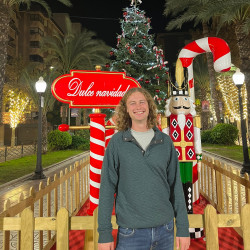 Michael Mulrennan posing in front of holiday decorations