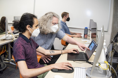 Associate Professor Peter Drake and a student researcher working on the Cascadia 9.0 game, summer...