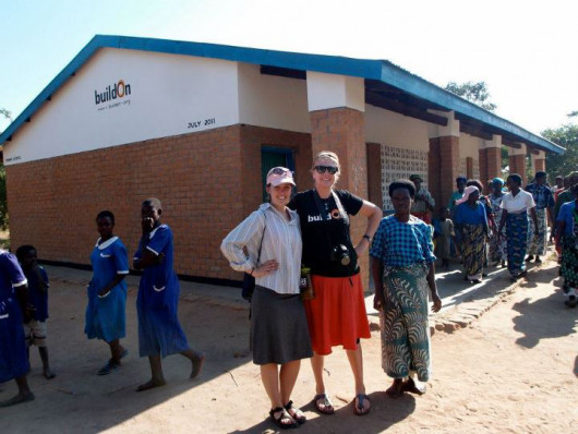 A finished BuildOn school outside Kasungu, Malawi. Lana Sanford ?15 and Anna Lofstrand ?13 stand ...