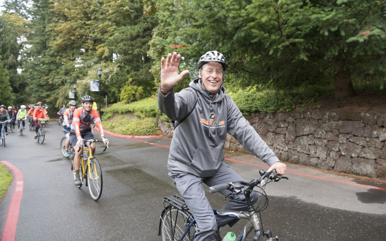 Wim Wiewel leads a community bike ride on his first day as president.