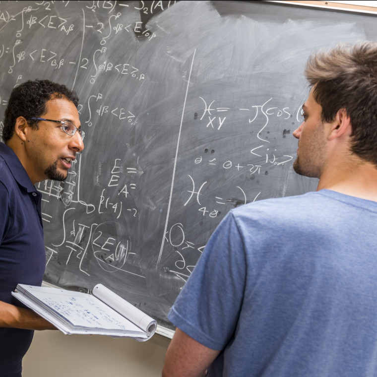 Physics professor Mohamed Anber and physics major Ben Kolligs '18 work through a theoretical physics problem together.